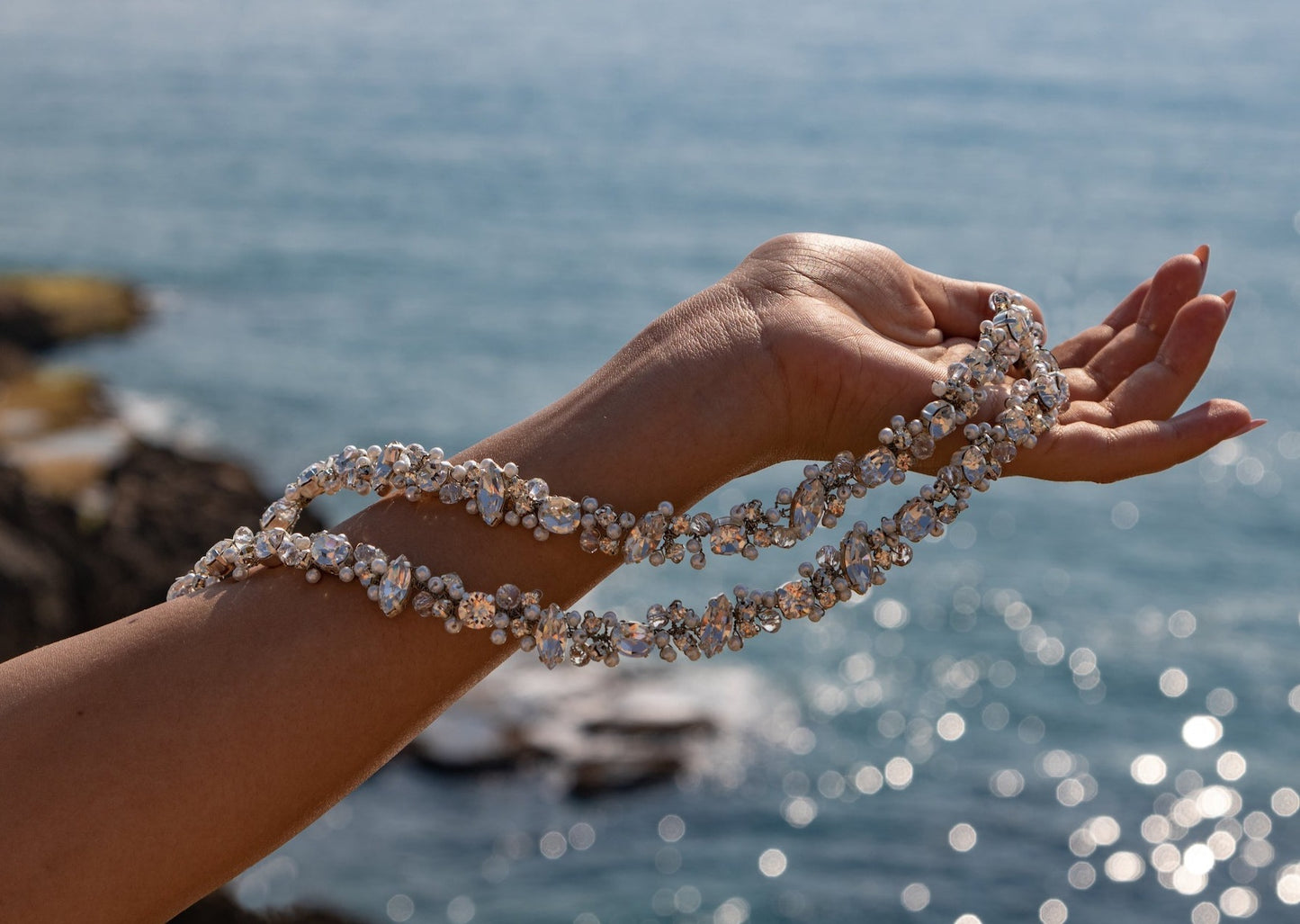Close-up image showcasing the intricate details of the Blair headband, adorned with Swarovski crystals, small white pearls, and sparkling clear crystals.