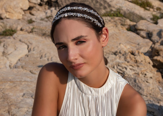 A model wearing the Blair headband, an accessory adorned with Swarovski crystals, small white pearls, and sparkling clear crystals. 