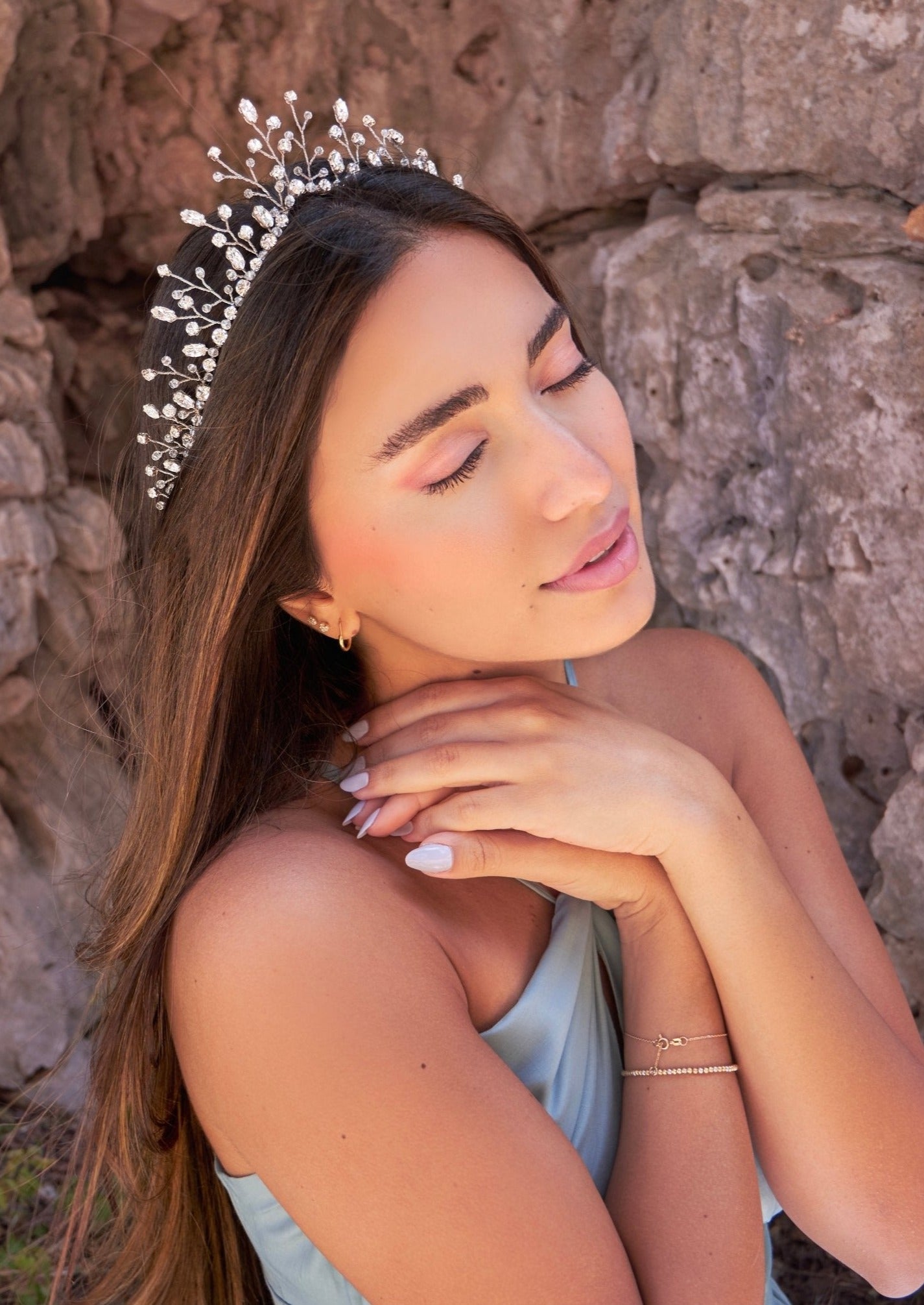 A model wearing the Stella crown, adorned with Swarovski, pearls, and sparkling crystal accents.